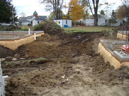 Backfilling between the house and garage foundations.