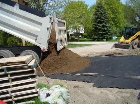Dumping the gravel at the front of the driveway.