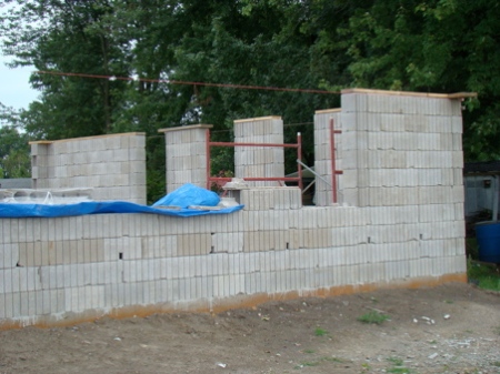 Saturday, August 22, west wall and NW corner to first window, blocks to the top of window ready for framing.